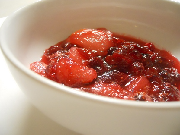 Bright red Cranberry Pear Sauce in a white bowl