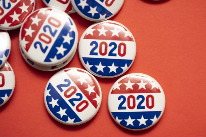 2020 buttons in red white and blue scattered over a red background