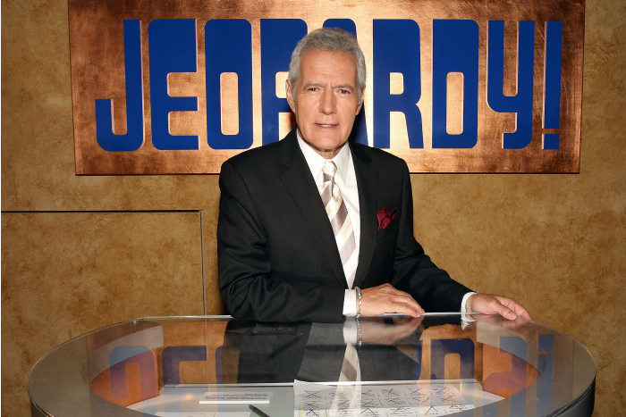 Alex Trebek poses on Jeopardy set 