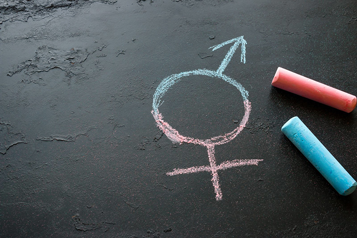 female and male symbol combined and written with chalk