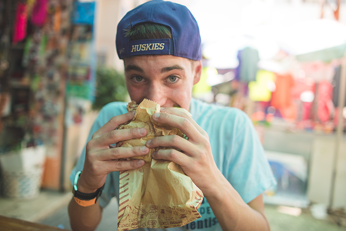 an image of a NFTY In Israel participant eating something out of a paper bag