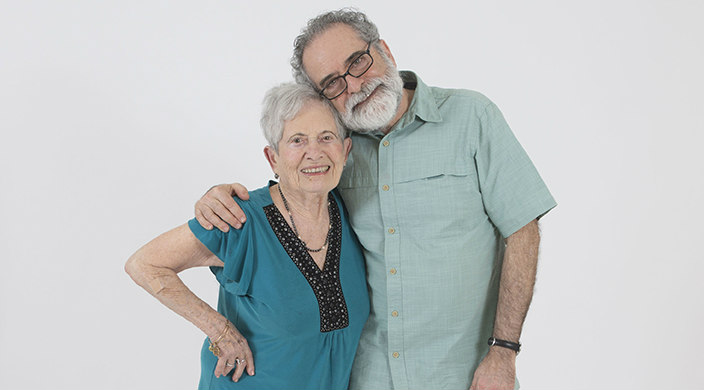 The author and his elderly mother posing together against a white background
