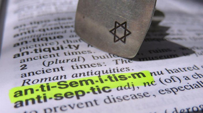 Closeup of a dictionary page defining AntiSemitism with the word highlighted in yellow