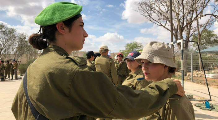 Women in Israeli military with arm on shoulder of URJ Heller High student