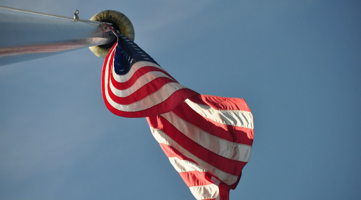 American flag on a flagpole with the photo taken from below 
