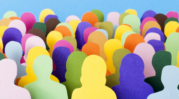 Colorful paper cutouts depicting a group of people 