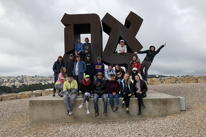 Heller HIgh Students posing in front of the Ahava sign