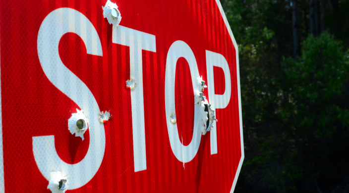 stop sign with bullet holes