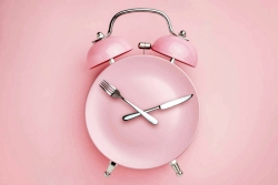 pink clock with utensils 