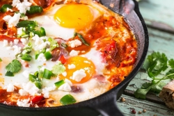 Mexican Shakshuka in a cast iron pan topped with cilantro