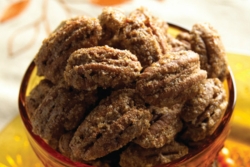 Spiced angel pecans piled in a small red bowl