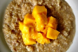 Sweet brown rice pudding with mango on top 