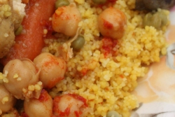 Close up of couscous with chickpeas tomatoes and other veggies 