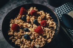 Bowl of granola topped with berries