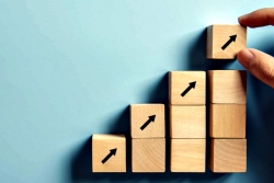 Building blocks in an upward trajectory with arrows pointing up