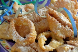 Rounds of fried dough on a plate with confetti in the background