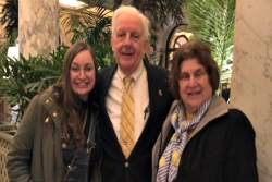 The author poses with her grandparents in what looks like a hotel lobby