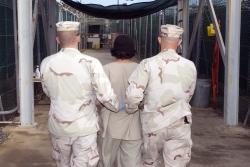 U.S. Soldiers Lead a Detainee through the Prison at Guantanamo Bay