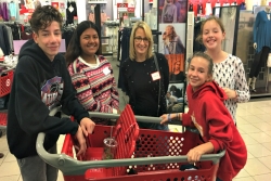 Happy children and adults with a shopping cart inside a Kohls