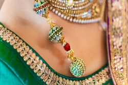 Closeup of a belly dancers stomach adorned with silk and jewels