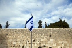 Israeli flag in front of Jerusalem stone at the Kotel