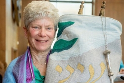Judy Leavitt holding a Torah for her Bat Mitzvah
