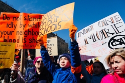 Young students at the March for Our Lives, holding signs about gun violence prevention