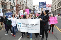 Womens March protesters carrying a sign for the Religious Action Center of Reform Judaism