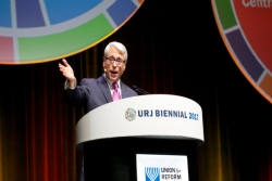 Rabbi David Stern standing on stage in front of the URJ Biennial backdrop 