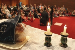 Challah and candlesticks at the head of a congregation