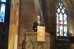 Rabbi Stephen Fuchs speaking from the podium in St. Giles Cathedral in Edinburgh Scotland