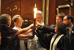 Jewish congregants practicing the candle lighting ritual of Havdallah