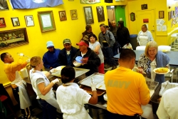 people serving food in a soup kitchen