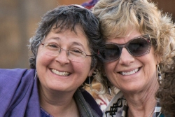 Two smiling middleaged women wearing kippot