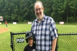 The author's son and grandson at a Little League baseball field