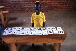 Ugandan Jewish child studying Hebrew alphabet