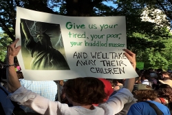Woman holding sign that reads "Give us your tired, your poor, your huddled masses... and we'll take away their children" at a rally 