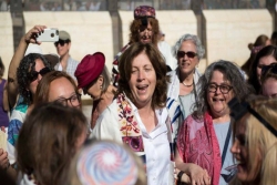 Anat Hoffman surrounded by other women at the Kotel (Western Wall)
