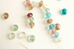 Loose beads of different colors; some strung on a string