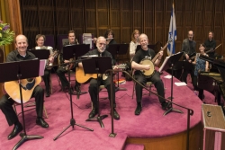 Baby boomers involved in a synagogue band on the bimah