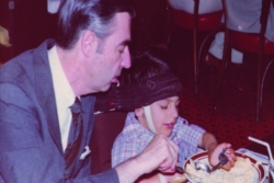 Mr. Rogers helping Jeff Erlanger with breakfast of scrambled eggs