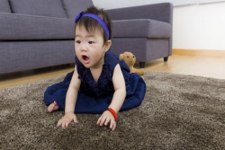 Chinese toddler on the floor in a living room