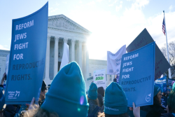People holding signs outside of the Supreme Court that say "Reform Jews Fight for Reproductive Rights"
