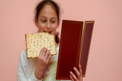 girl eating a passover sandwich 