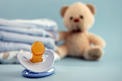 pacifier teddy bear and diapers