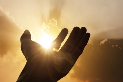 hand reaching towards the sun
