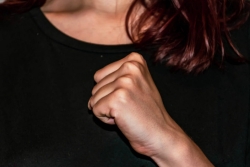 Closeup of a womans hand thumping her chest as during the reciting of the Al Cheit prayer