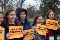 A line of high school students hold signs supporting the DREAM Act during the 2018 L'Taken seminar in Washington, D.C.