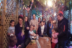 Rabbi Grushcow with children and adults in the sukkah