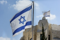 Israeli flags flying in front of Jerusalem building